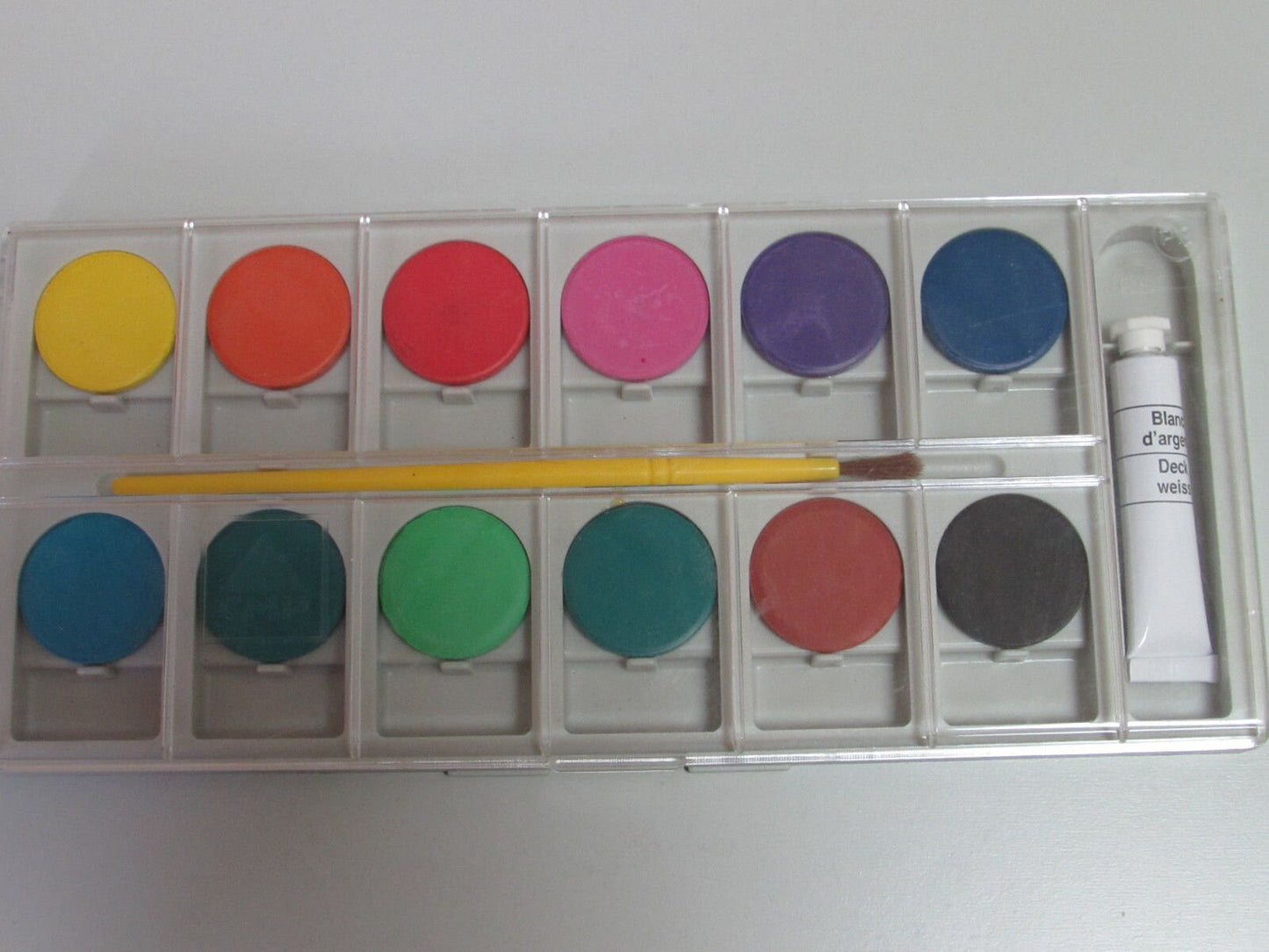 Set of watercolor paints with brush